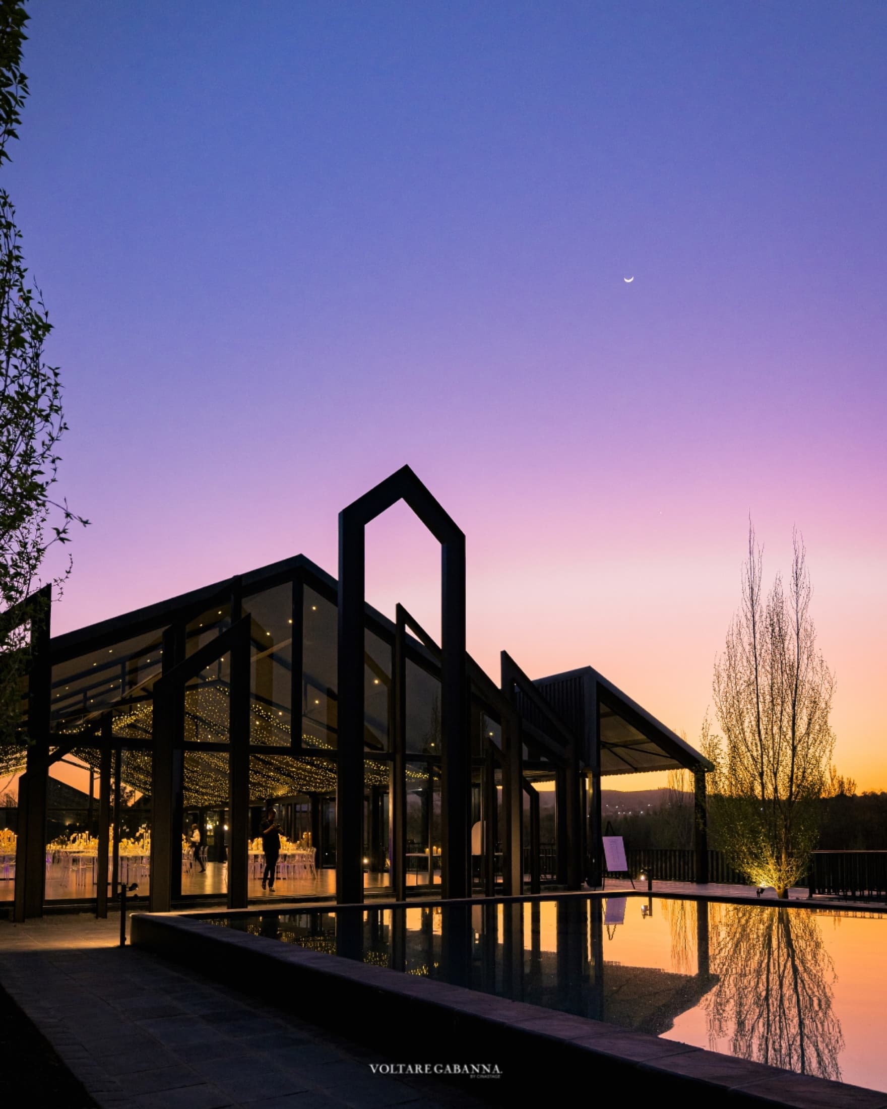 The reception hall and reflection pool at dusk